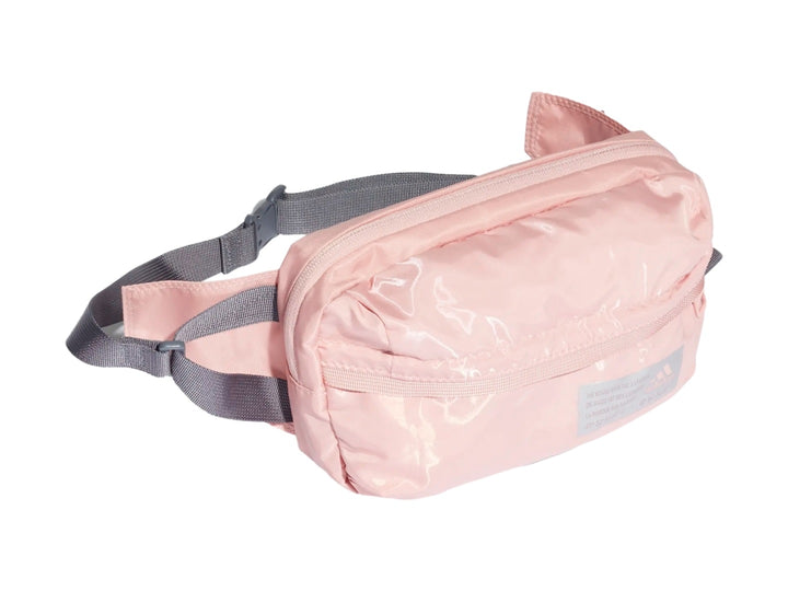 Riñonera Adidas de color rosa con correa gris y cierre frontal.