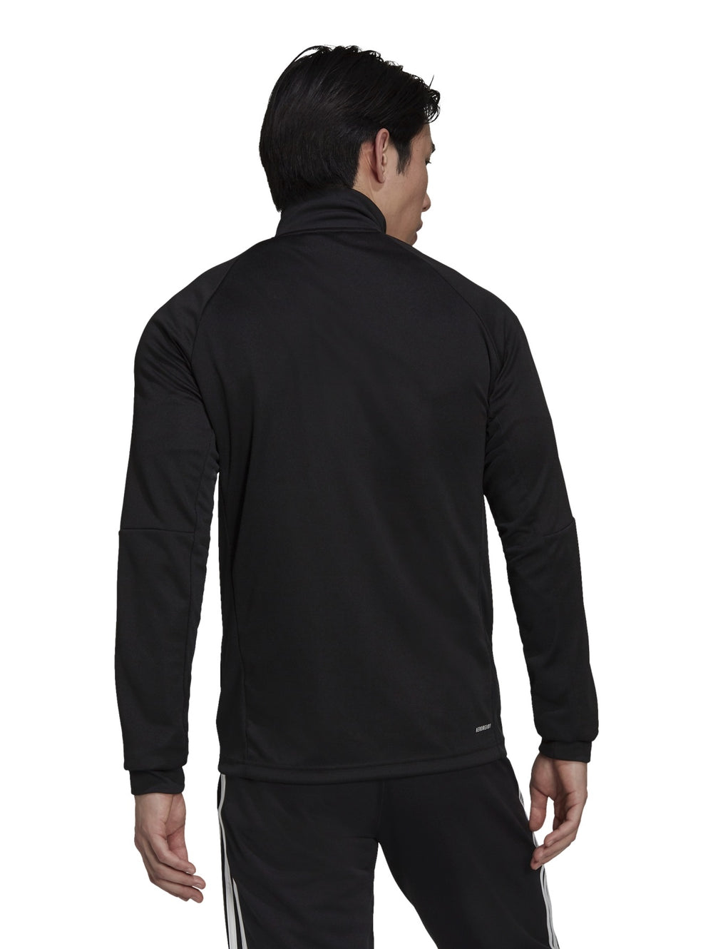 Hombre vistiendo chaqueta deportiva Adidas Aeroready Sereno Cut color negro con rayas blancas laterales.