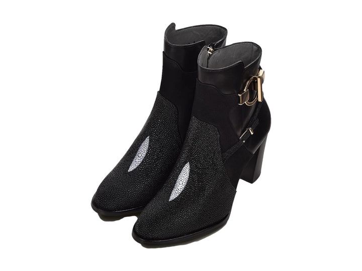 Botín negro de cuero con tacón alto y detalles de hebillas doradas.