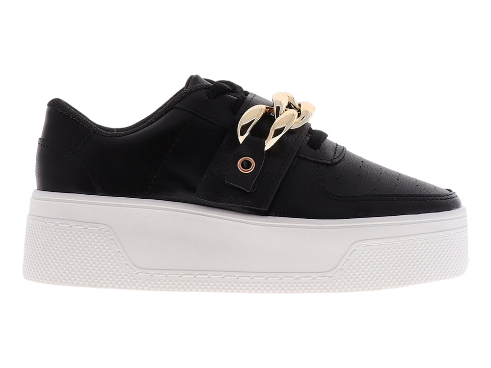Tenis negros de plataforma con suela blanca y detalle de cadena dorada en la parte superior.