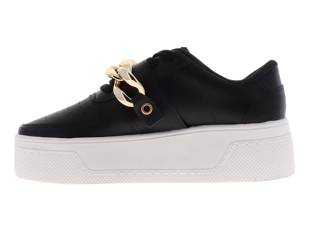 Tenis negros de plataforma con suela blanca y detalle de cadena dorada en la parte superior.