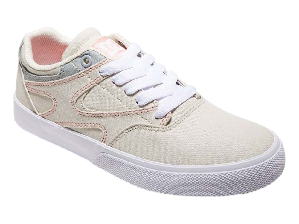 Tenis DC Shoes color beige con detalles en gris y costuras rosas, suela blanca, vista lateral.