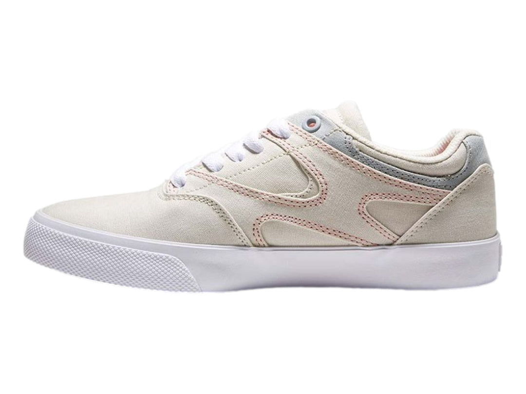 Tenis DC Shoes color beige con detalles en gris y costuras rosas, suela blanca, vista lateral.