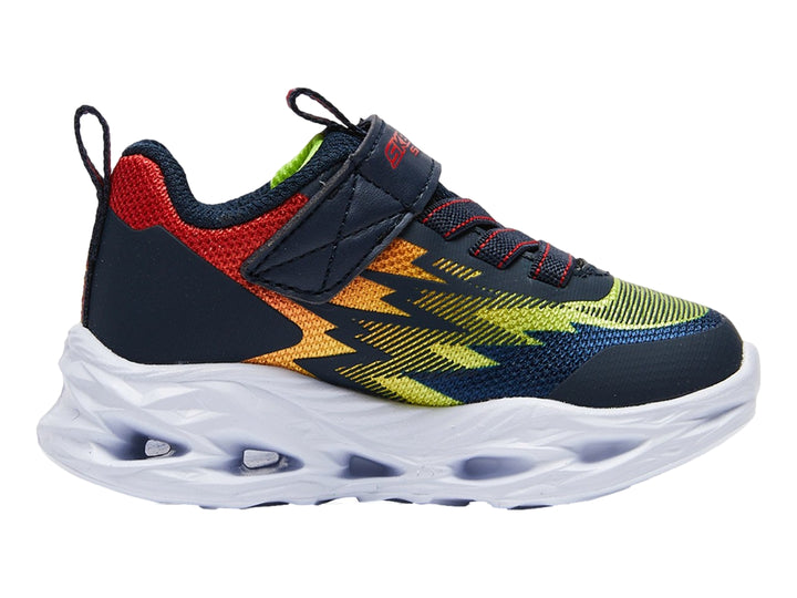 Tenis deportivos Skechers para niño en colores azul, rojo y amarillo con suela blanca robusta y cierre de velcro.