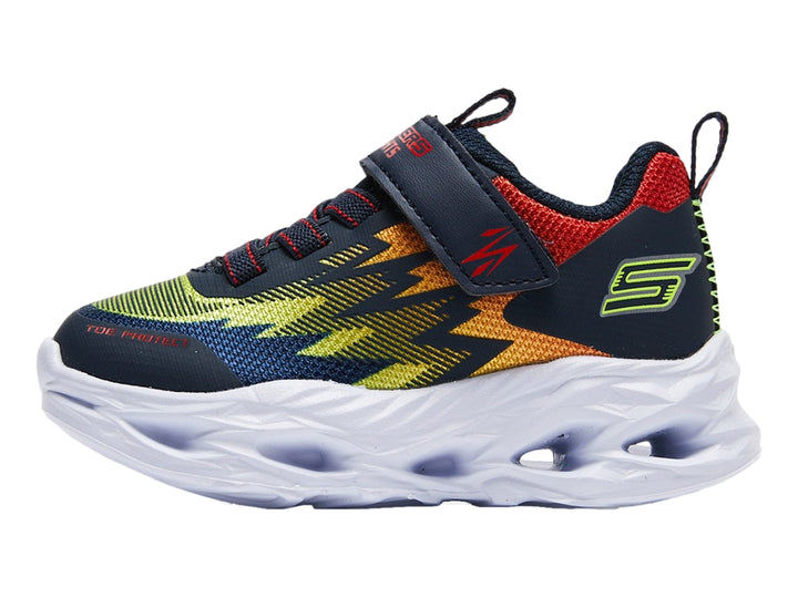 Tenis deportivos Skechers para niño en colores azul, rojo y amarillo con suela blanca robusta y cierre de velcro.