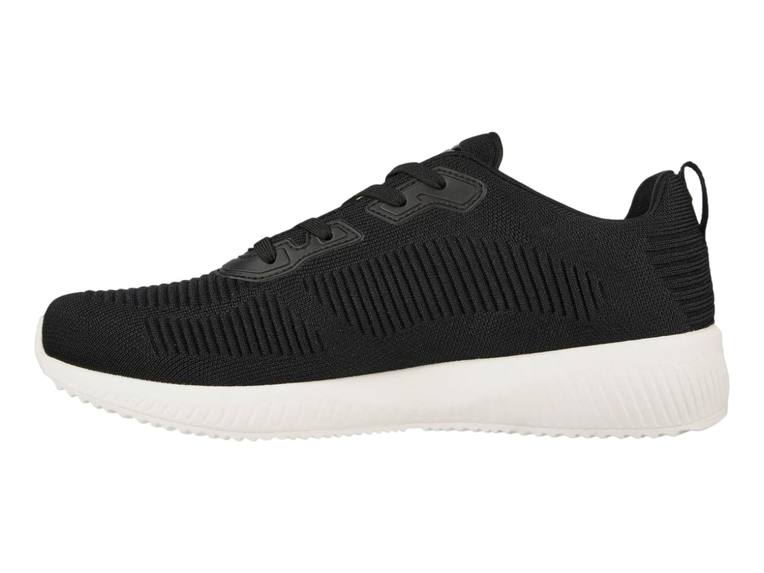 Tenis deportivos Skechers color negro con suela blanca y tejido acanalado.