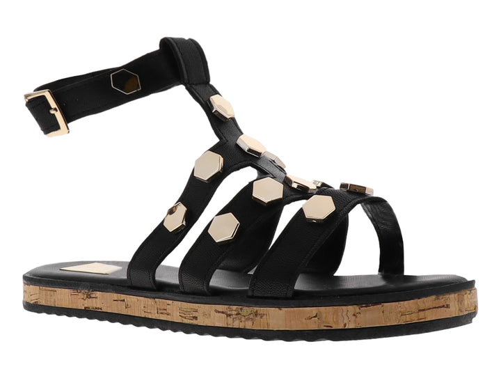 Sandalia casual negra con detalles hexagonales dorados y suela de corcho.