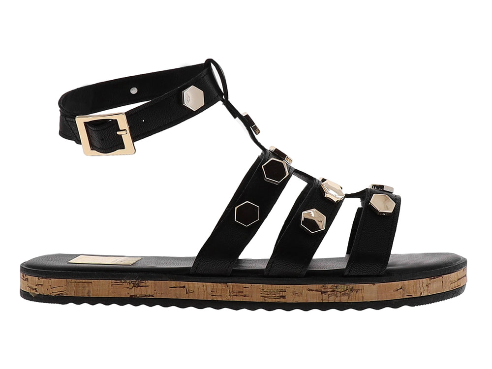 Sandalia casual negra con detalles hexagonales dorados y suela de corcho.