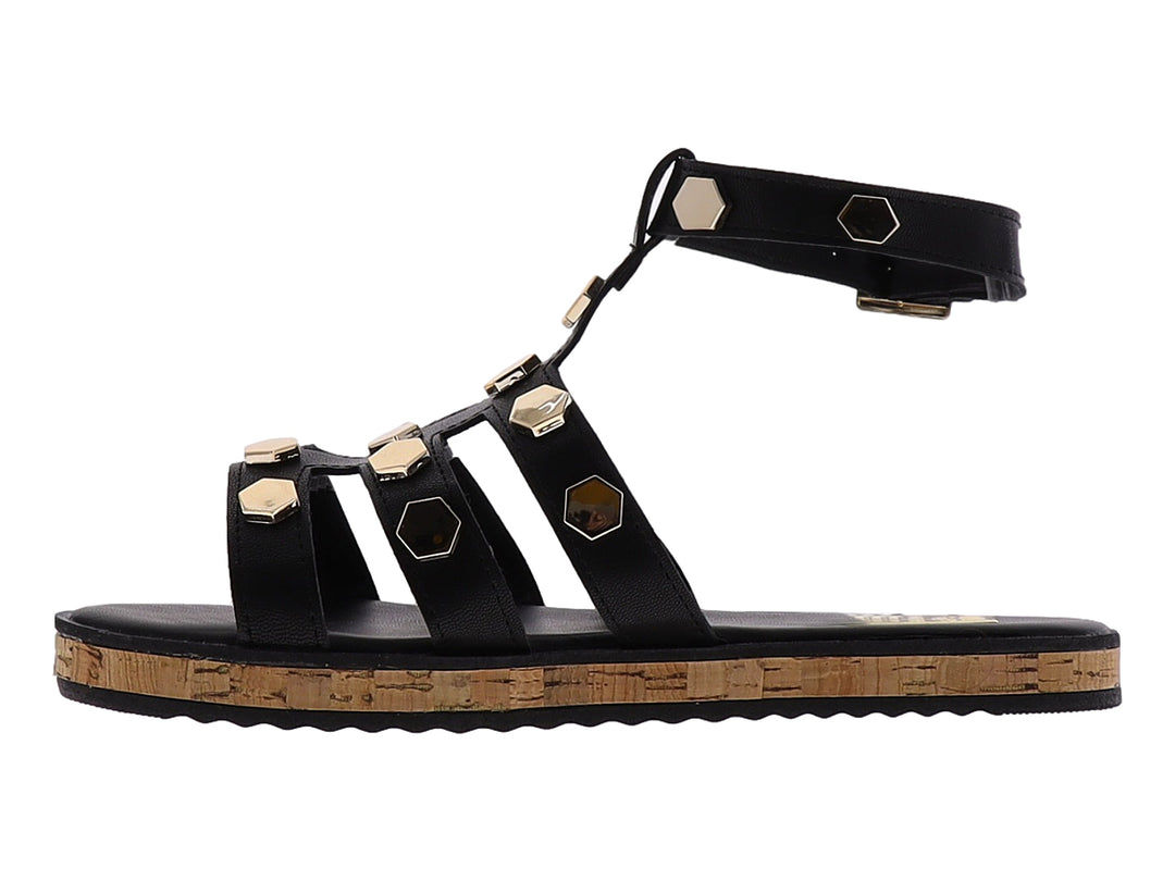 Sandalia casual negra con detalles hexagonales dorados y suela de corcho.