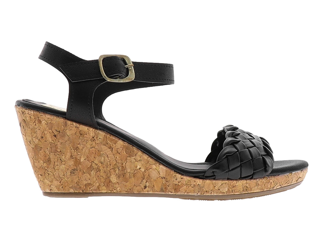 Sandalia de cuña color negro con correa trenzada y plataforma de corcho.