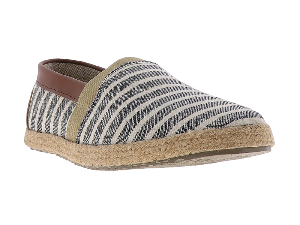 Zapato plano tipo alpargata con rayas beige y negro, suela de yute y detalle marrón en el talón.