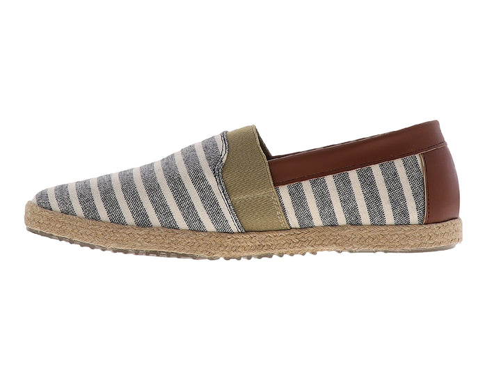 Zapato plano tipo alpargata con rayas beige y negro, suela de yute y detalle marrón en el talón.