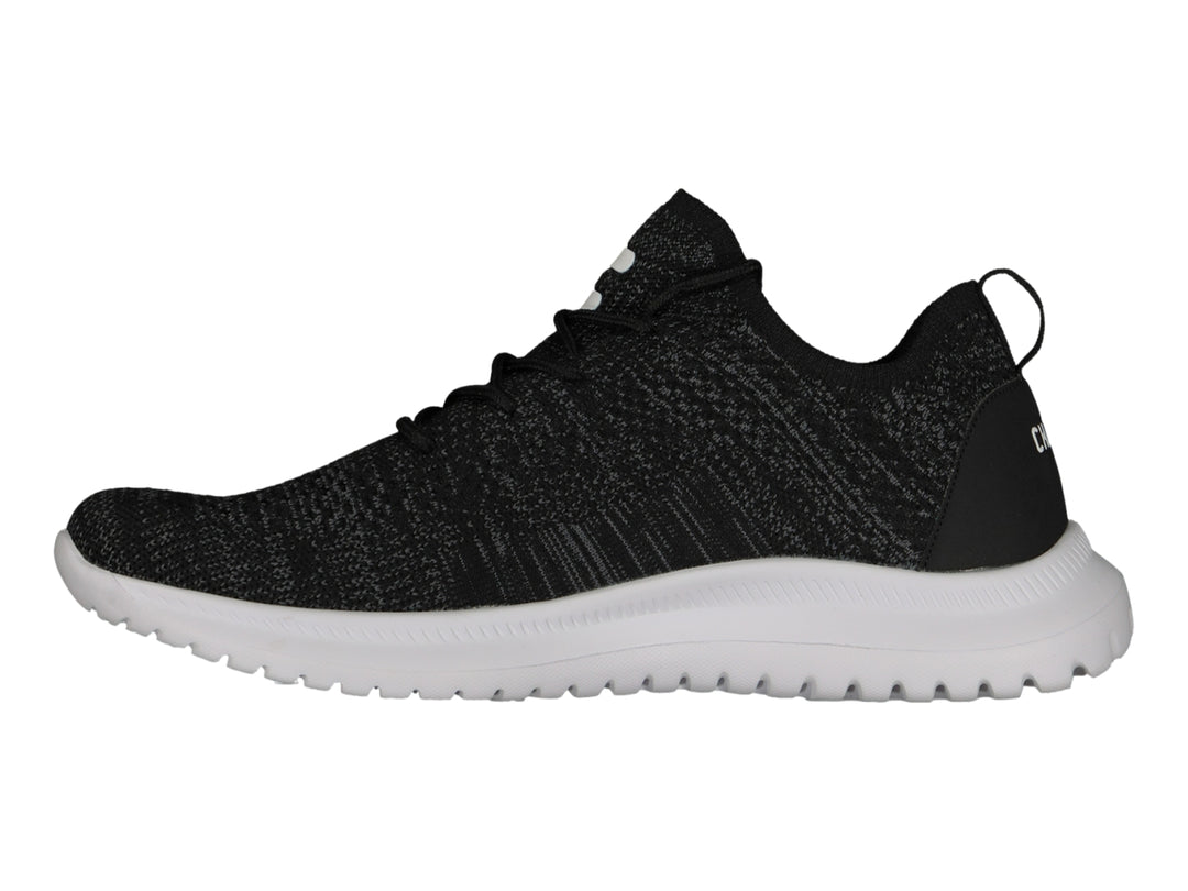 Tenis deportivos Charly color negro con suela blanca y tejido transpirable.