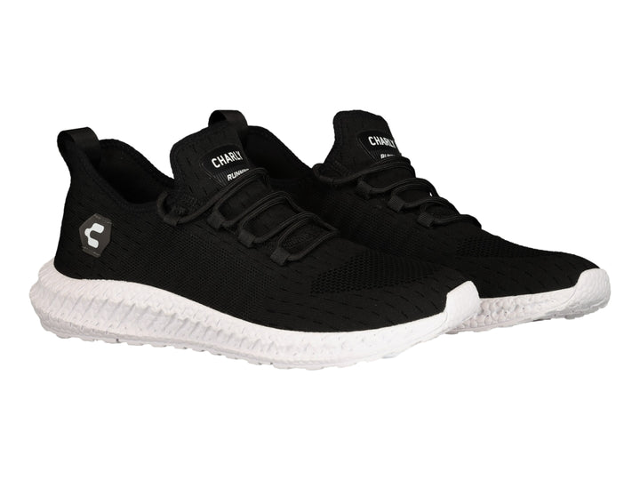 Tenis deportivos Charly color negro con suela blanca y tejido transpirable.