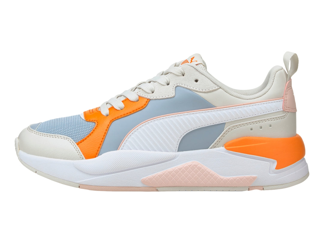 Tenis PUMA X-Ray Game en colores blanco, azul claro y naranja con suela gruesa blanca.
