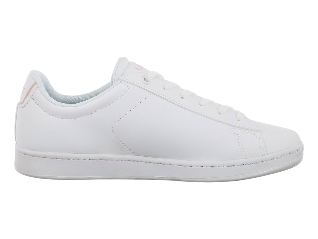Tenis blancos de corte bajo con detalles en rosa claro en el talón y suela blanca.