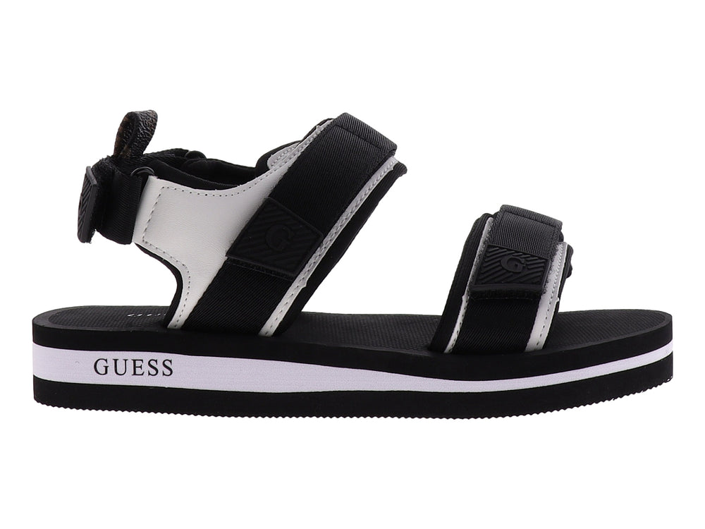 Sandalia gladiador Guess color negro y blanco con correas ajustables y suela plana.