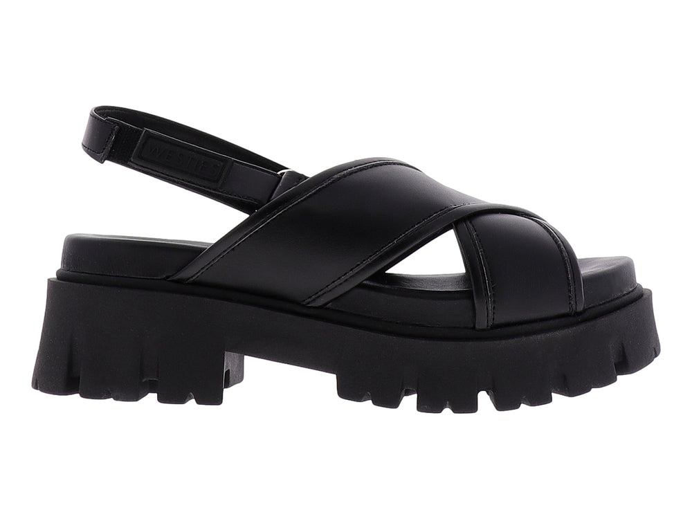 Sandalia negra de plataforma con correas cruzadas y suela gruesa dentada.
