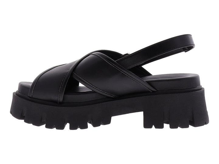 Sandalia negra de plataforma con correas cruzadas y suela gruesa dentada.
