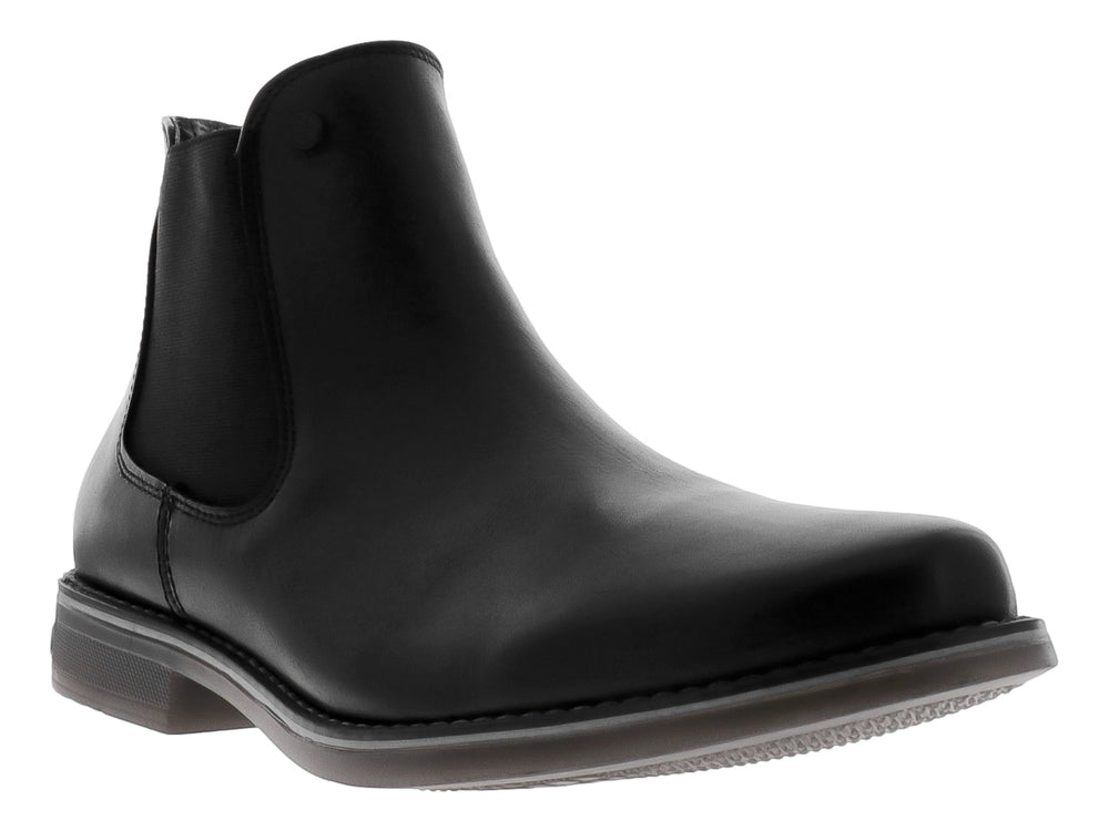Botín estilo Chelsea de cuero negro con panel elástico lateral y suela oscura.