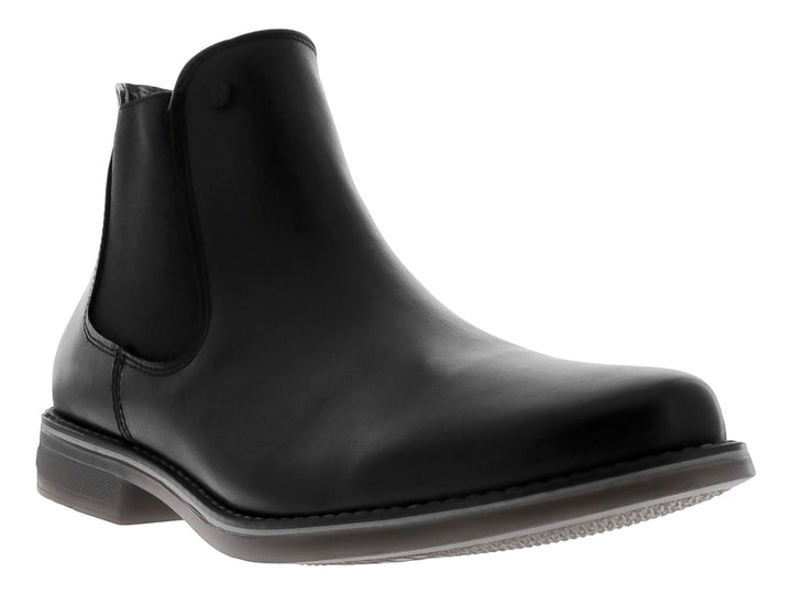 Botín estilo Chelsea de cuero negro con panel elástico lateral y suela oscura.