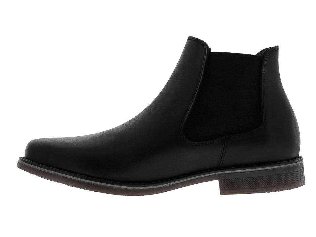 Botín estilo Chelsea de cuero negro con panel elástico lateral y suela oscura.