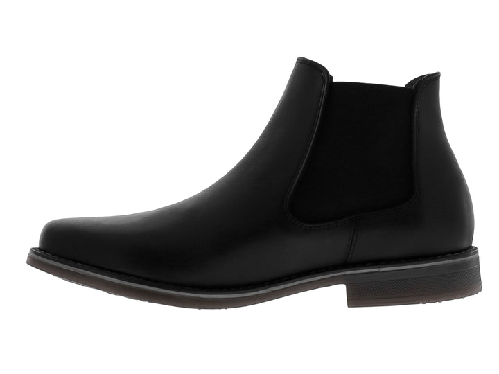 Botín estilo Chelsea de cuero negro con panel elástico lateral y suela oscura.