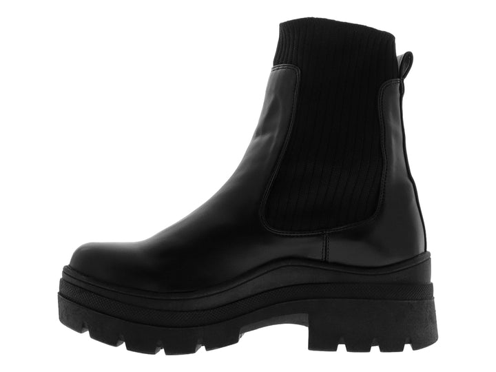 Bota negra de mujer con suela gruesa tipo track y panel elástico lateral.