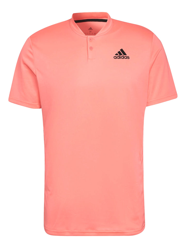 Hombre vistiendo playera deportiva Adidas color rojo ácido con logotipo negro en el pecho.