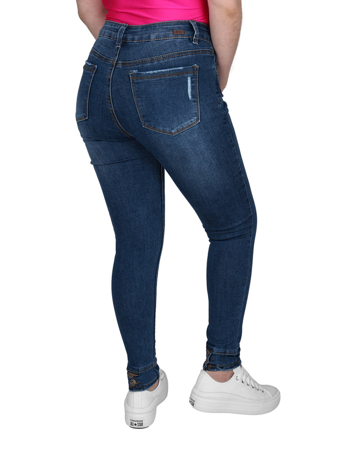 Pantalones jeans ajustados color azul con detalles de destrucción en las piernas.