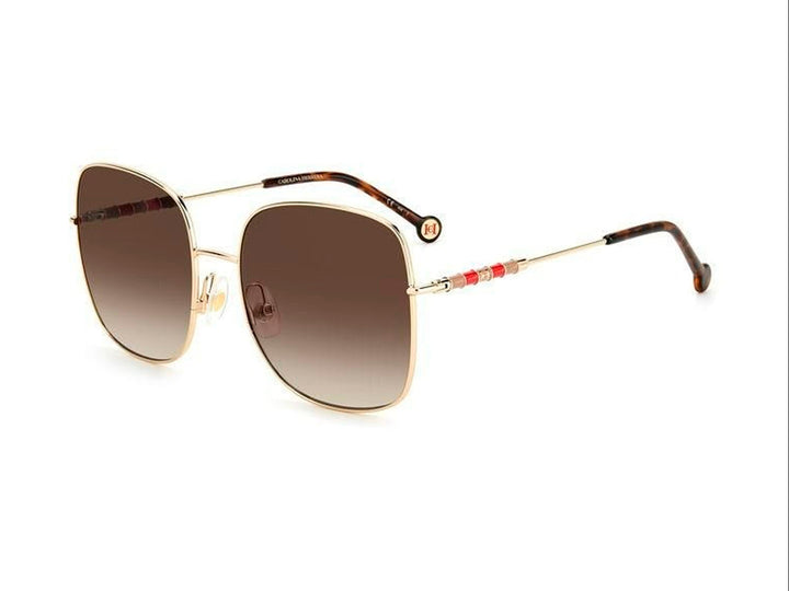 Lentes de sol Carolina Herrera con montura cuadrada dorada y cristales en tono marrón degradado.