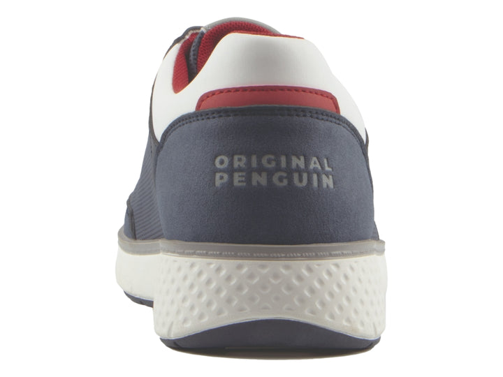 Tenis Penguin color azul marino con detalles en blanco y rojo, suela blanca y agujetas blancas.