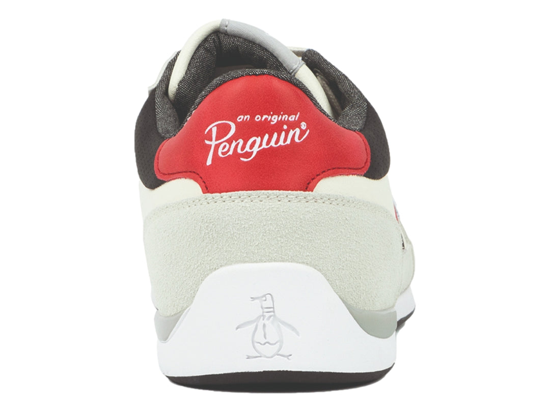 Tenis Penguin color beige con franjas laterales en rojo y negro y suela blanca.