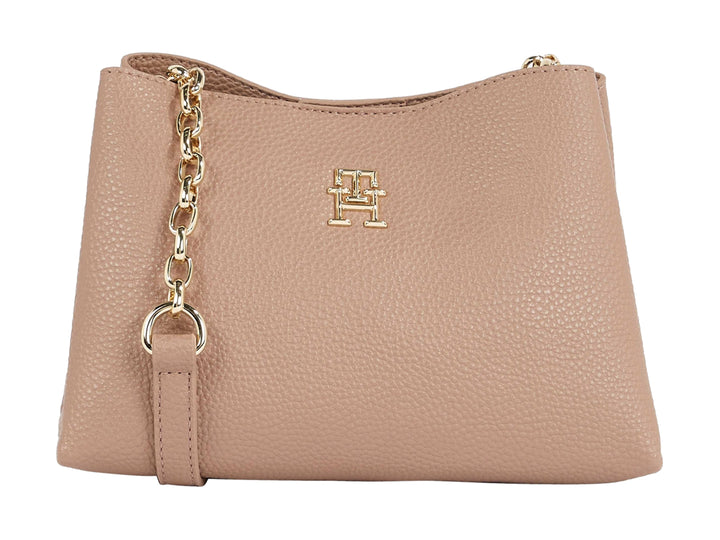 Bolso Tommy Hilfiger color beige con textura graneada, cadena dorada y logo metálico frontal.