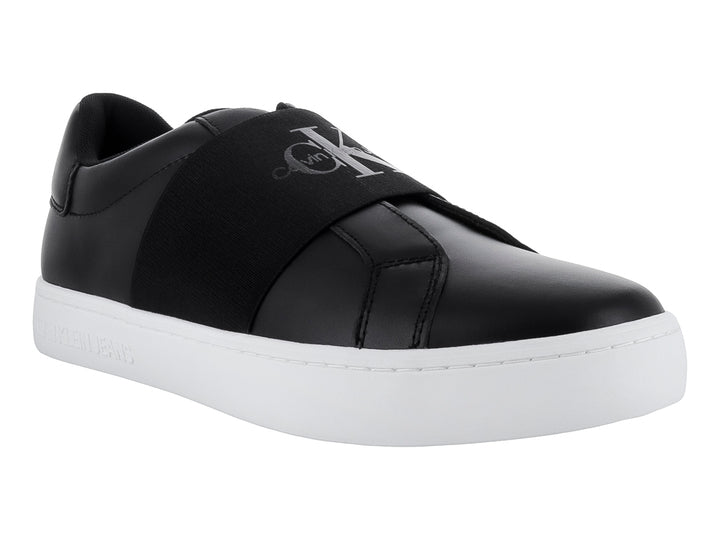 Tenis Calvin Klein color negro con suela blanca y banda elástica frontal, estilo casual slip-on.