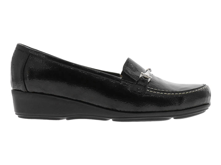Zapato tipo mocasín color negro brillante con adorno metálico plateado en la parte superior.