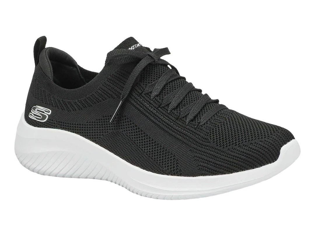 Tenis deportivos Skechers para mujer en color negro con suela blanca.