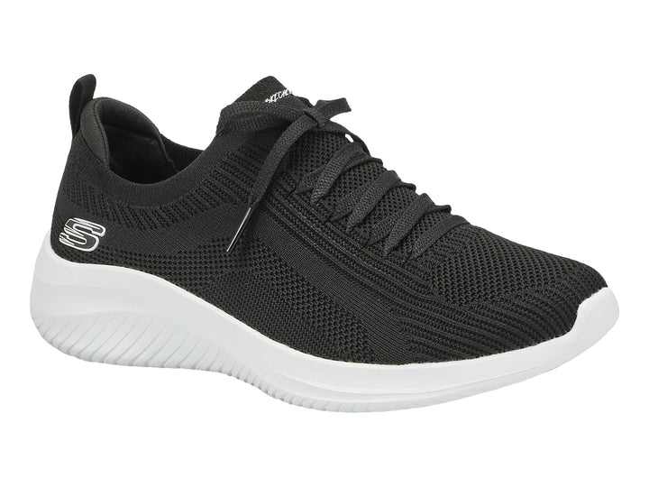 Tenis deportivos Skechers para mujer en color negro con suela blanca.