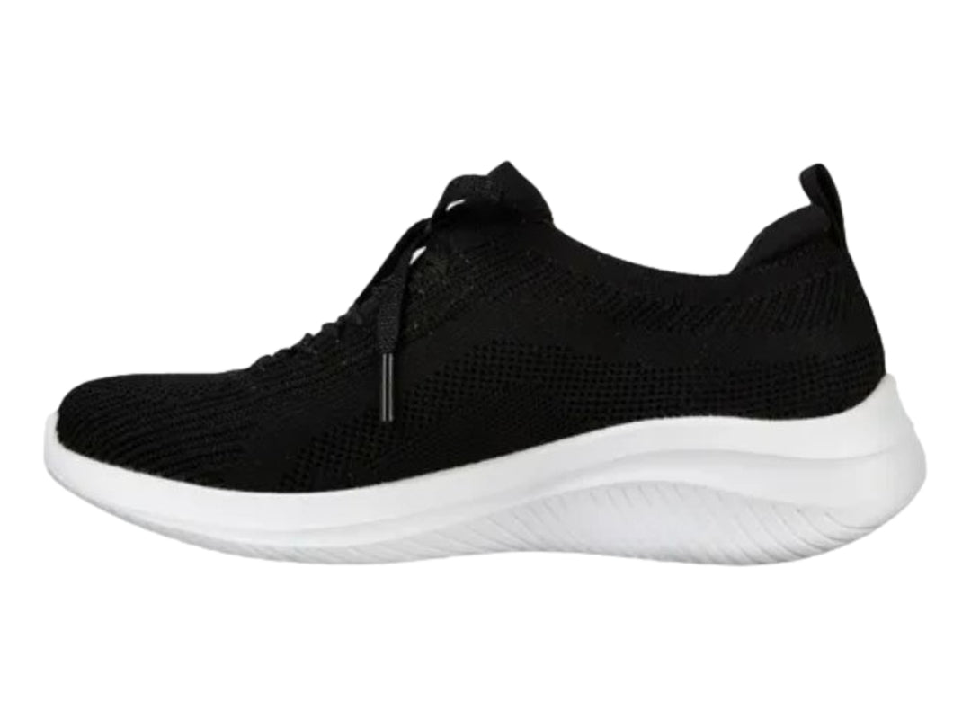 Tenis deportivos Skechers para mujer en color negro con suela blanca.