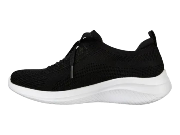 Tenis deportivos Skechers para mujer en color negro con suela blanca.