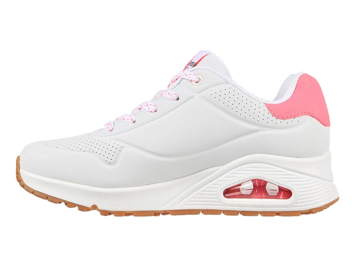 Tenis deportivos Skechers color blanco con detalles en rosa y suela café, diseñados para mujer.