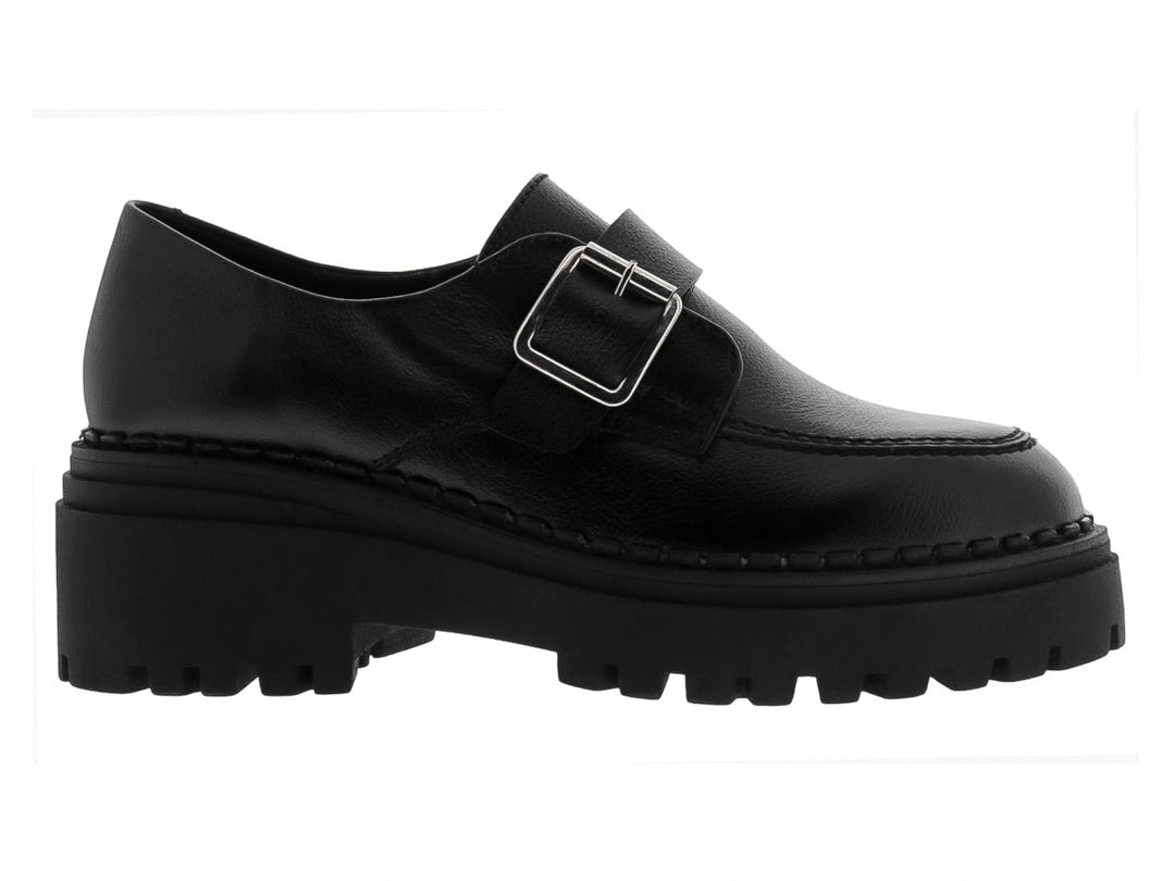Mocasines negros para mujer con suela track gruesa y hebilla metálica plateada.