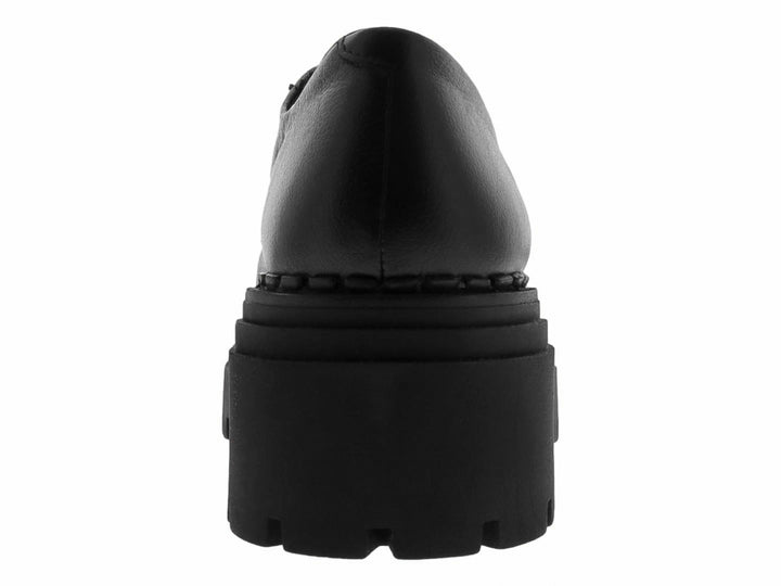 Mocasines negros para mujer con suela track gruesa y hebilla metálica plateada.
