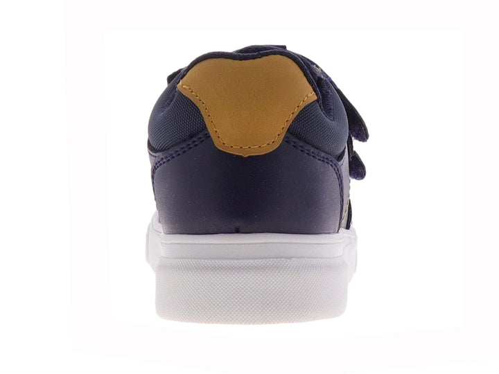 Tenis para niño color azul marino con suela blanca y cierre de velcro.