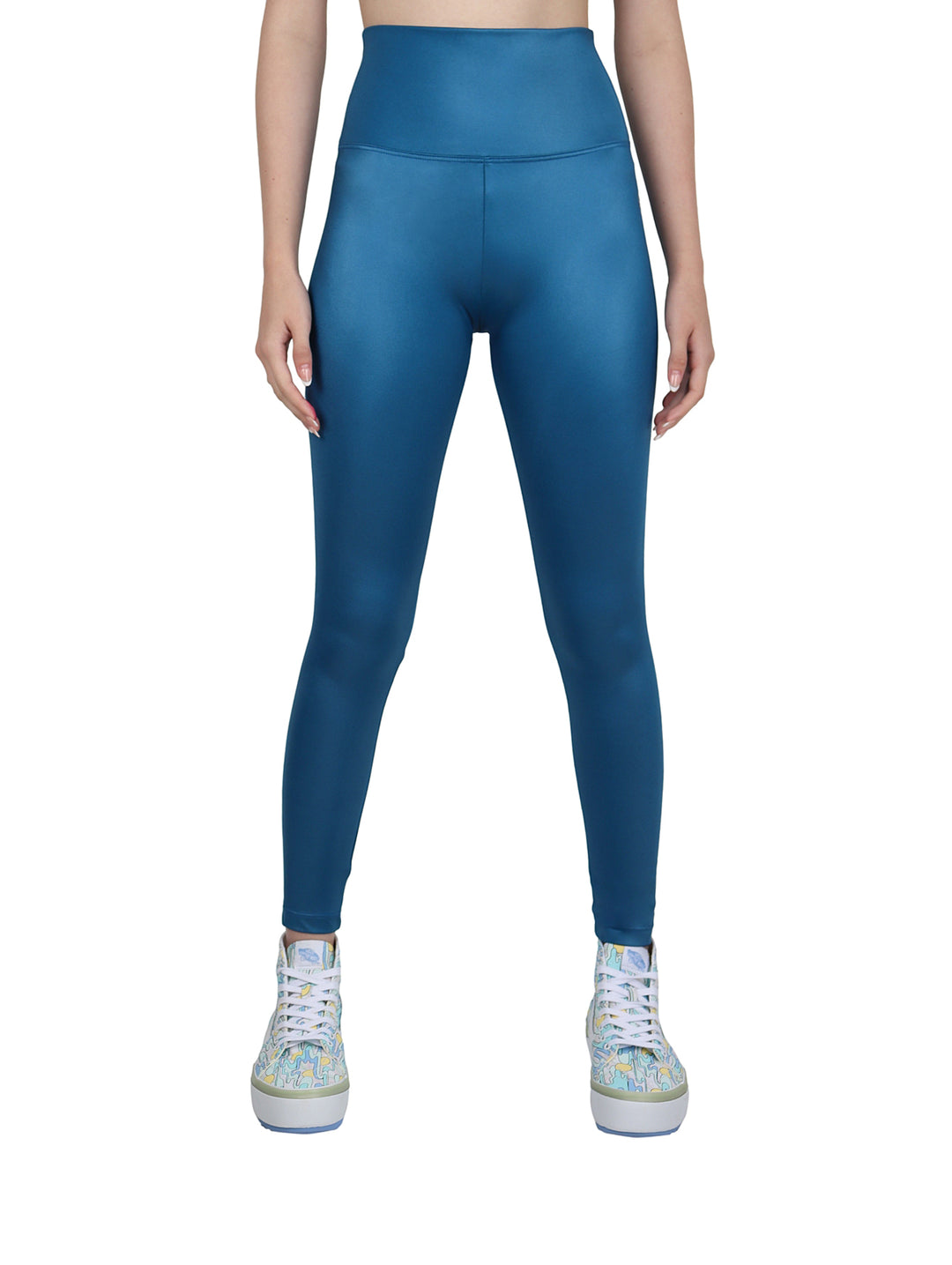 Mujer vistiendo leggings deportivos de color petroleo con talle alto y acabado brillante.
