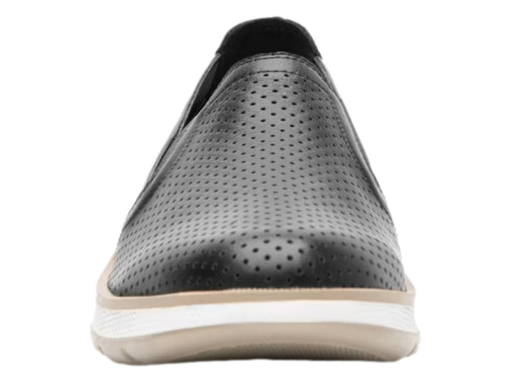 Zapato plano Flexi color negro de cuero perforado con suela blanca y beige para mujer.
