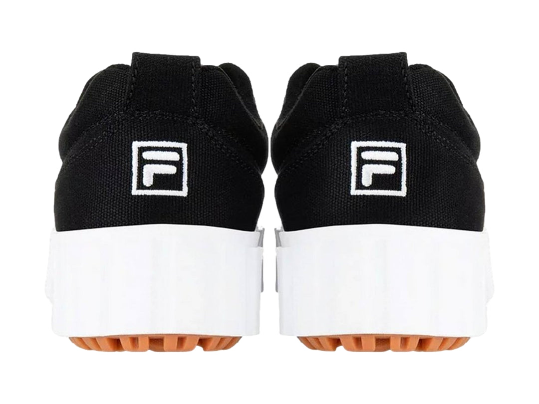 Tenis FILA negros con suela de plataforma blanca y base color café.