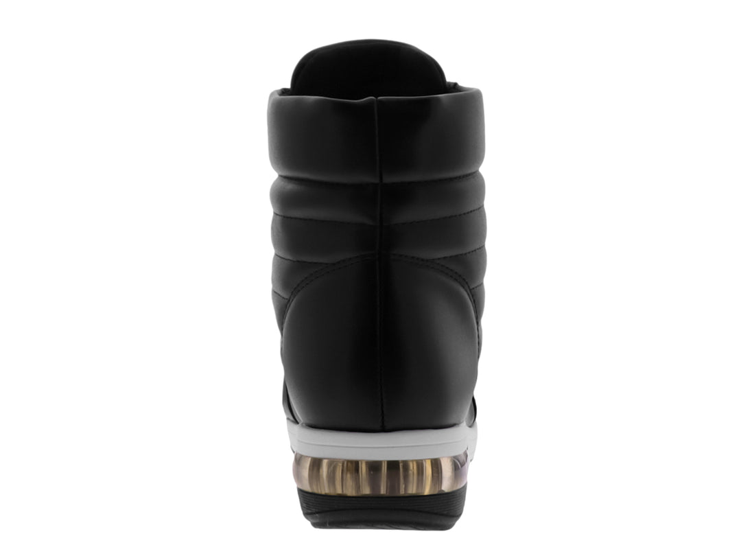 Botín negro para mujer con suela blanca y detalles dorados en los ojillos.