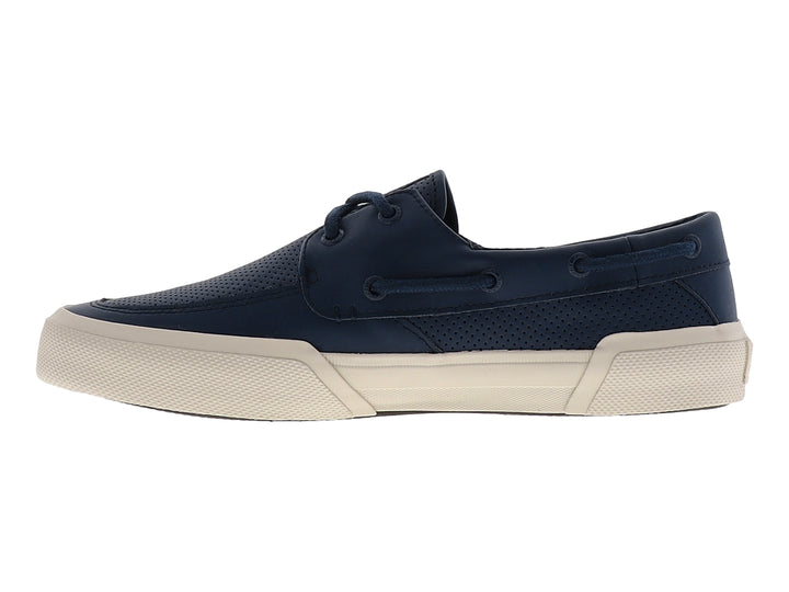 Zapato náutico Sperry azul marino con suela beige y superficie perforada.