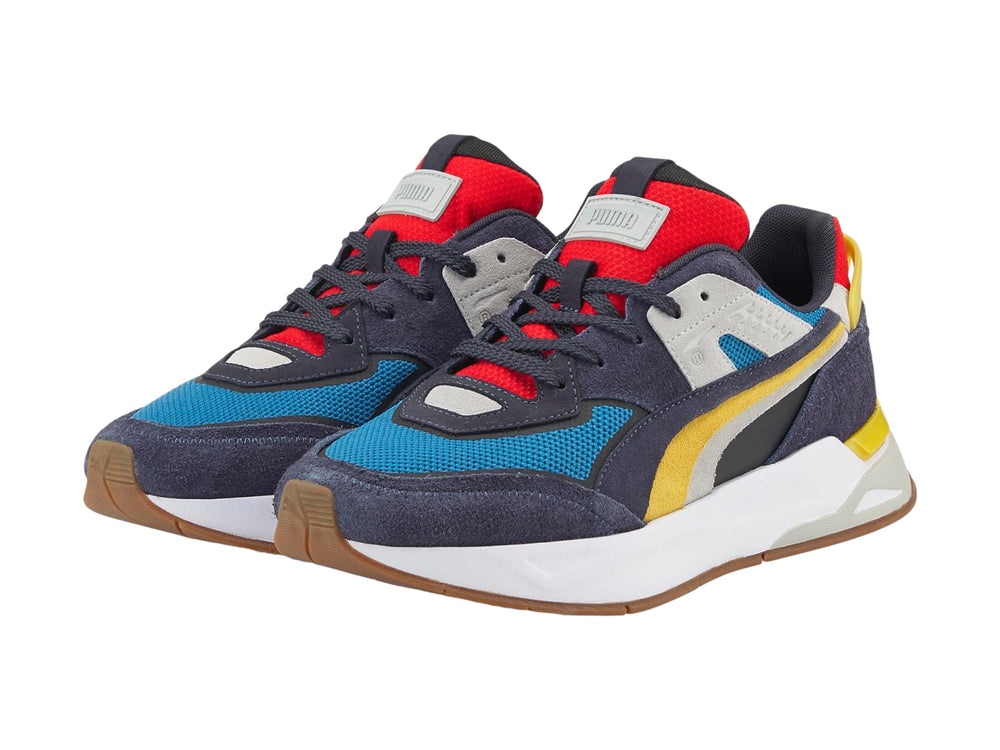 Tenis PUMA Mirage Sport Layers multicolor con detalles en azul, amarillo y rojo sobre suela blanca.